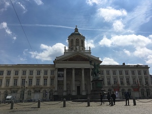 Neoclassical columned church with a bell tower on a Brussels square, an equestrian statue standing in front