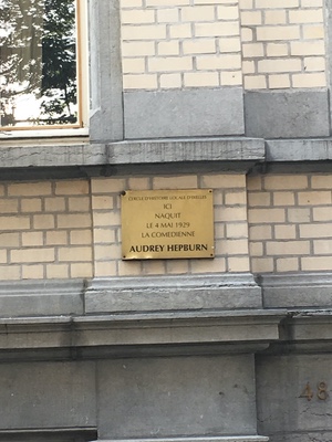 Brass plaque on a brick facade in Brussels marking the 1929 birthplace of actress Audrey Hepburn